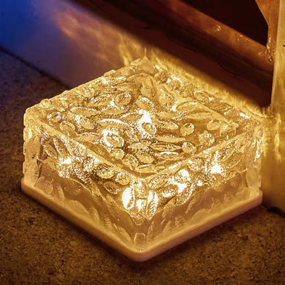 Nahaufnahme einer goldfarbenen Solar-Glaswürfelleuchte mit Warmweiß-Glanz